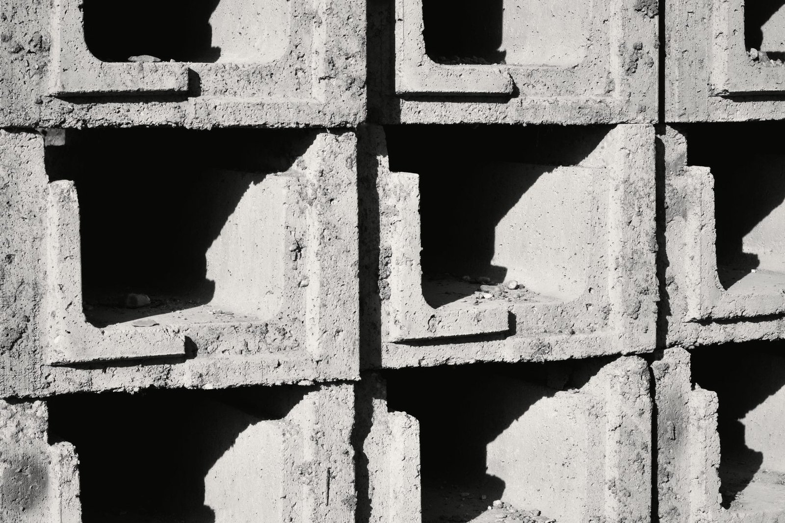 Concrete blocks stacked in rows on a site.