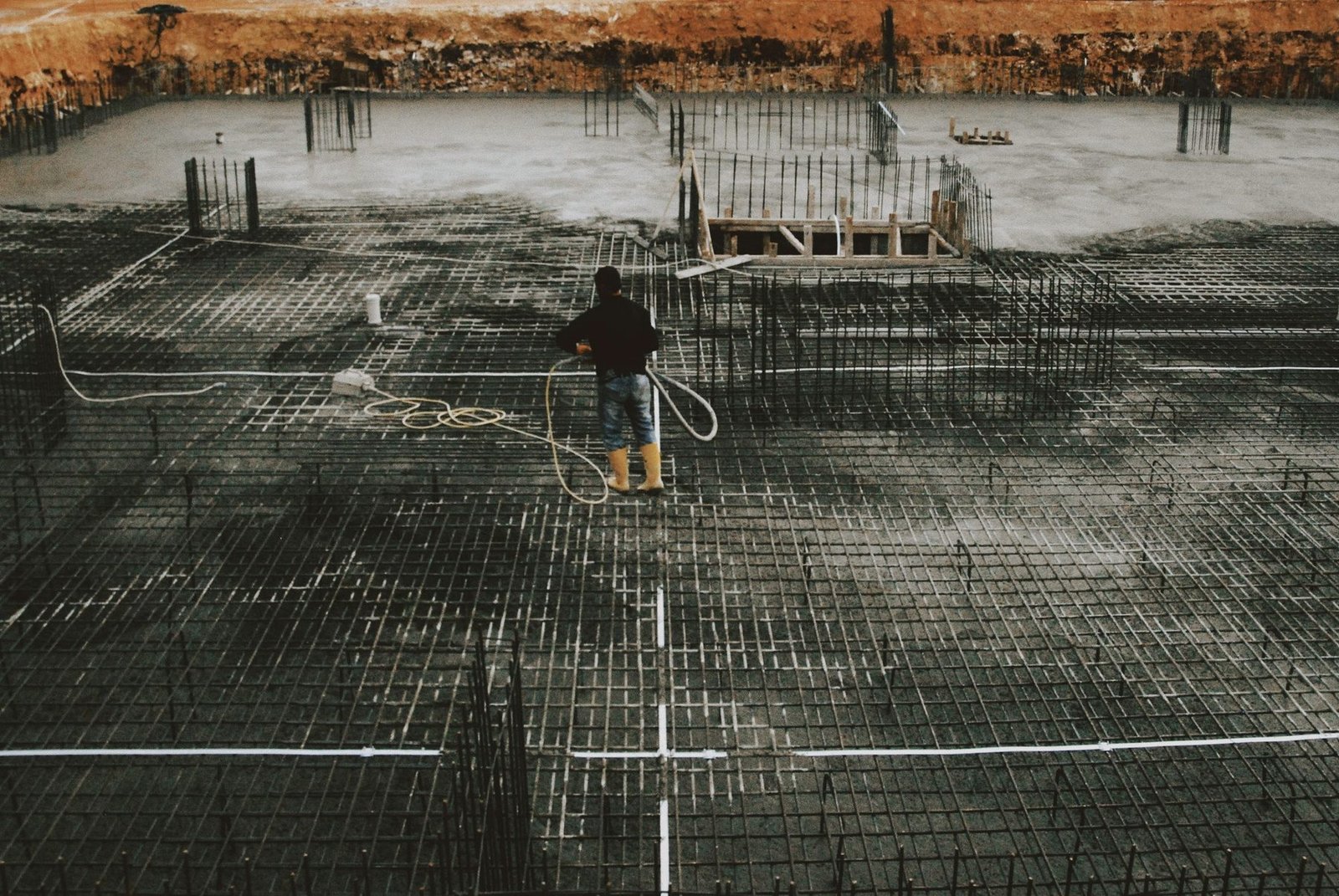A reinforced concrete slab with rebar grid laid out before a pour.